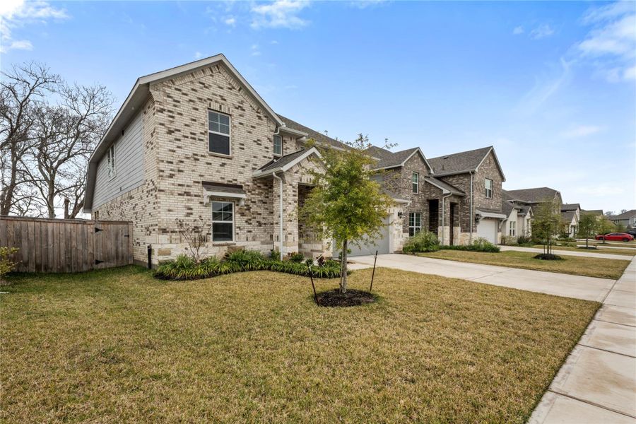 Charming front exterior with an inviting curb appeal, featuring a well-maintained lawn, clean architectural lines, and a welcoming entryway that reflects the quiet, family-friendly atmosphere of Bellfort Farms.