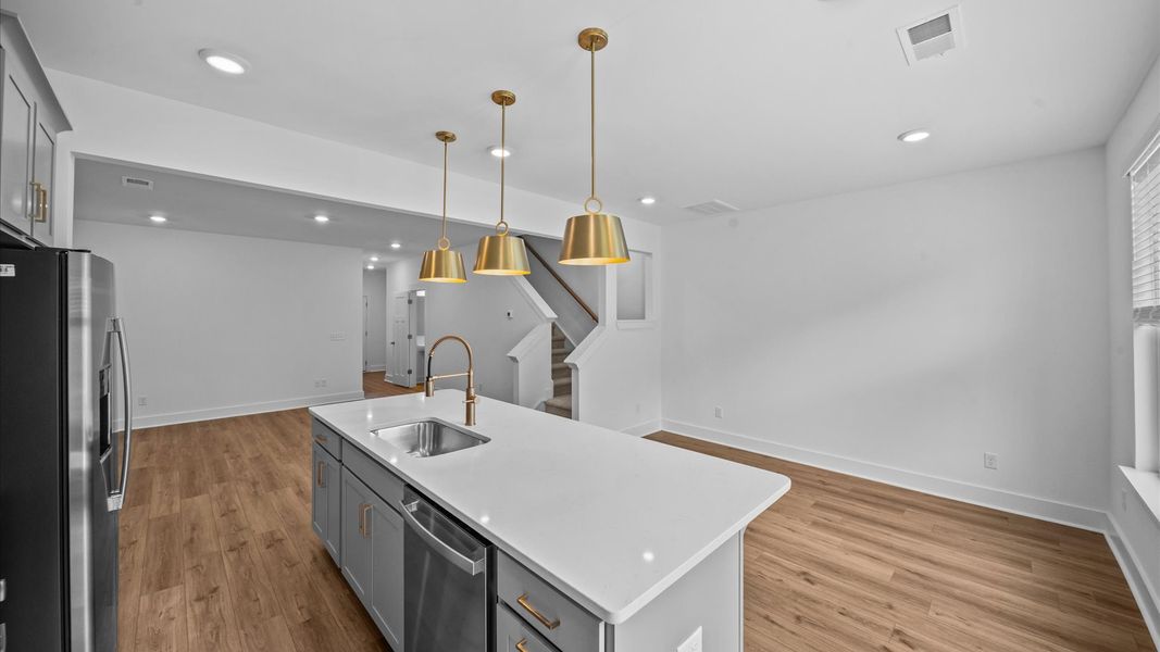 Tasteful kitchen with a streamlined island and modern finishes in a first-class DRB Homes design located at Ransdell Pointe