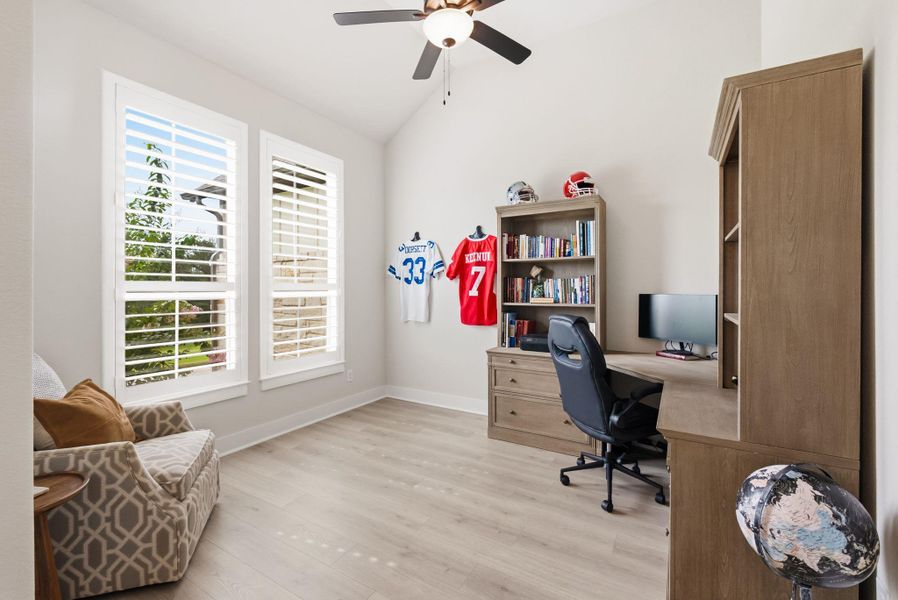 Located just to the left of the foyer, the dedicated home office features wood shuttered windows and plenty of space to stay focused, organized, and inspired during a quiet workday