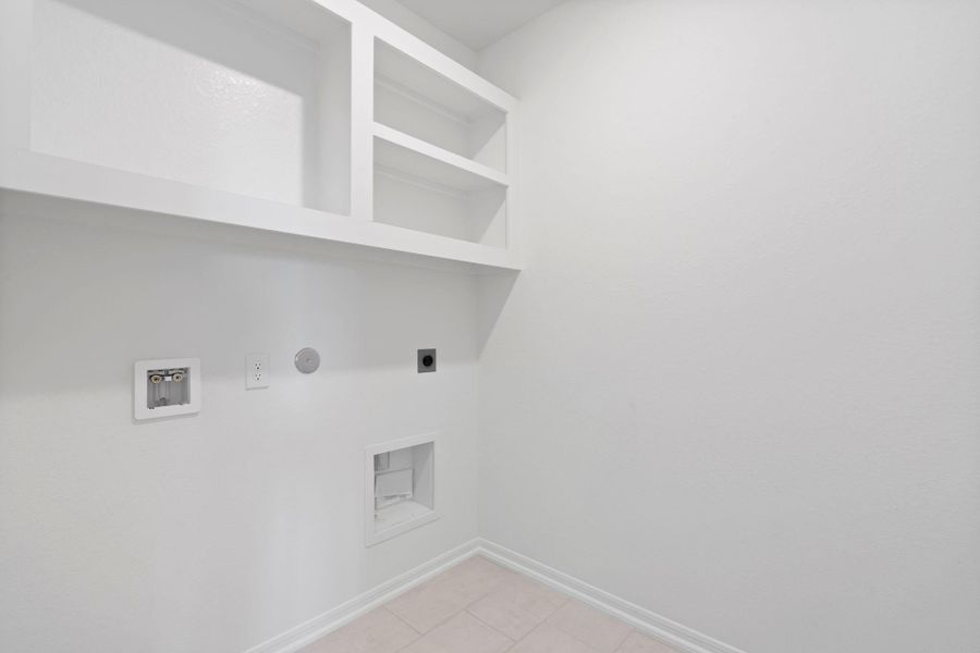 The laundry room layout is carefully planned for optimal workflow with designated areas for washing, drying, and storing.