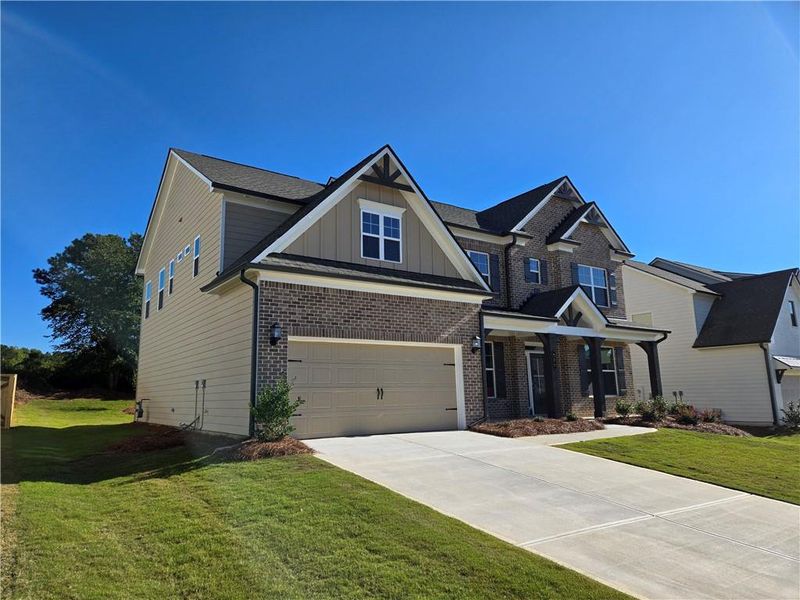 Front exterior of a new home in Enclave at Logan Point, Loganville, GA, highlighting curb appeal (Image 25). Front exterior of a new home in Enclave at Logan Point, Loganville, GA, highlighting curb appeal (Image 25).