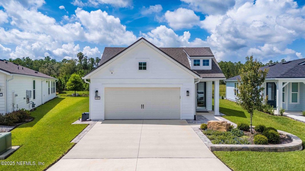 Front exterior of a new home in Summer Bay at Grand Oaks, St. Augustine, FL, highlighting curb appeal (Image 2). Front exterior of a new home in Summer Bay at Grand Oaks, St. Augustine, FL, highlighting curb appeal (Image 2).