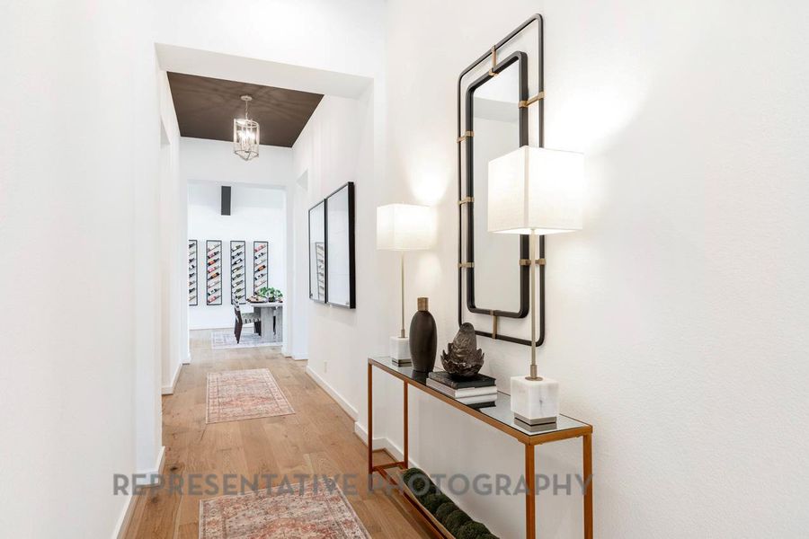 Hall with wood finished floors and baseboards