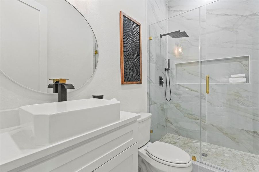 Full bathroom with vanity and a marble finish shower Full bathroom with vanity and a marble finish shower