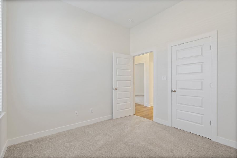 Unfurnished bedroom featuring baseboards and carpet flooring