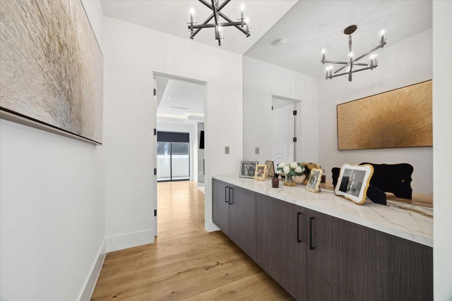 Enjoy the ultimate luxury of a private entrance to the primary suite, complete with ample built-in storage or option for coffee bar space