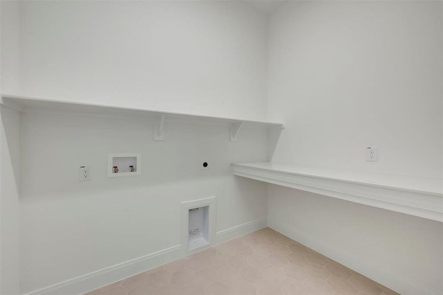 Laundry area with white walls and baseboards