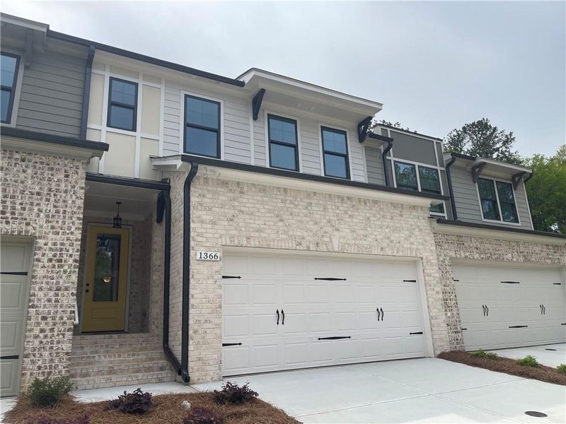 Front exterior of a home in the The Collection at Wolf Creek community, located in Lawrenceville, GA (Image 2).