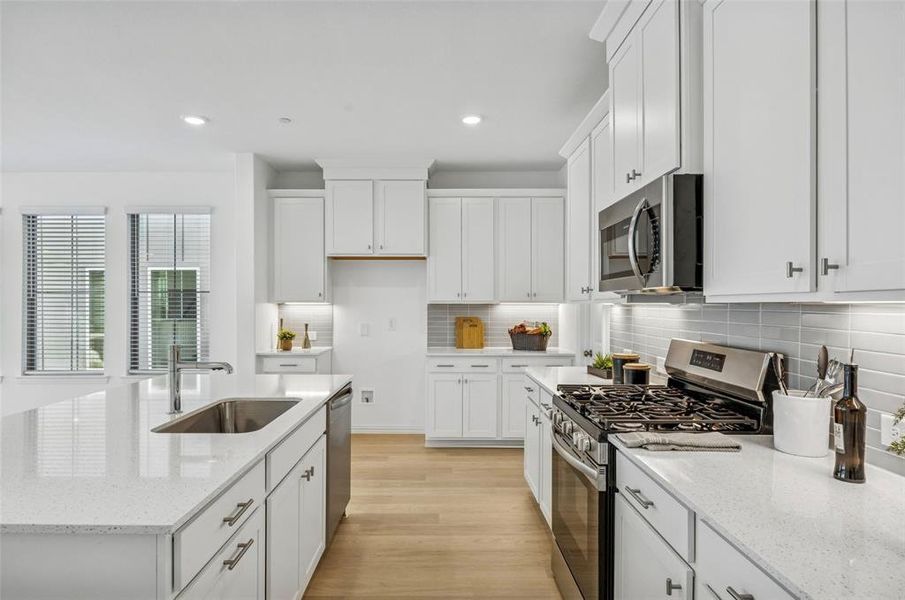 A beautiful backsplash, stainless appliances, pot & pan drawers and so much more can be found in this over the top kitchen!