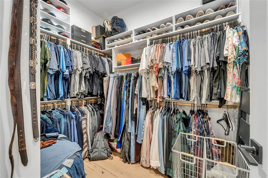 Walk in closet with light wood-type flooring Walk in closet with light wood-type flooring