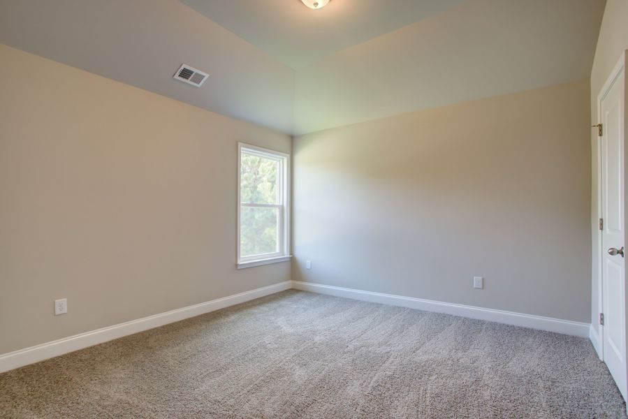 Spacious bedroom 2 with a walk in closet and bathroom