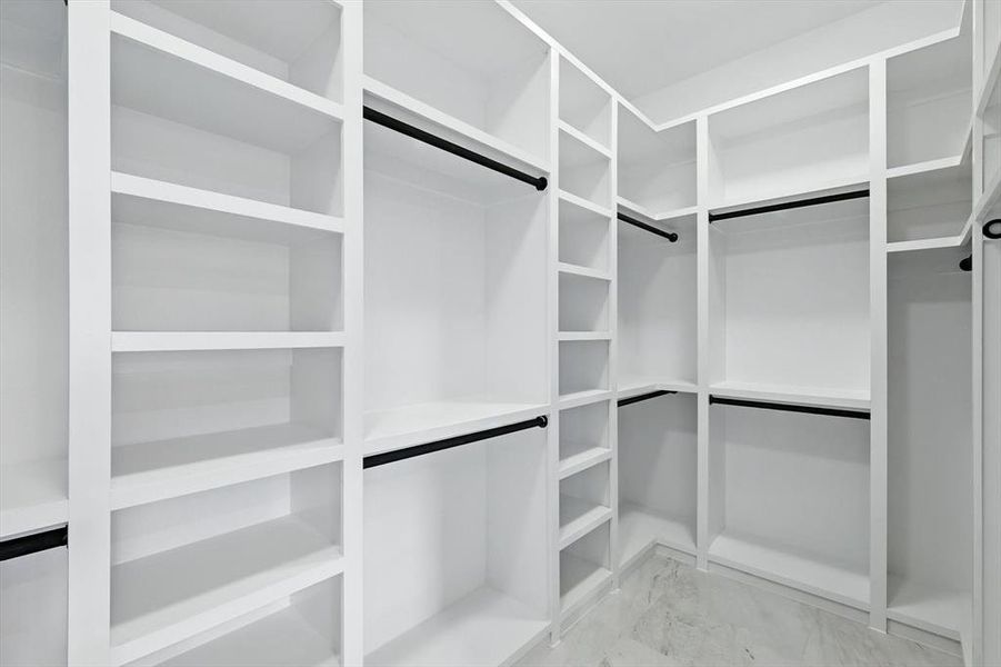 Spacious closet featuring light marble finish floors Spacious closet featuring light marble finish floors