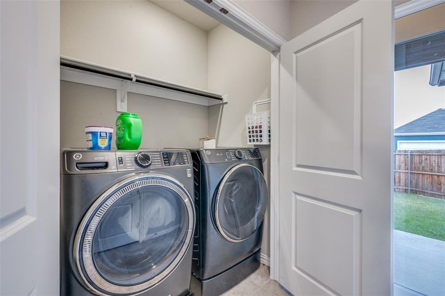 Washroom featuring washer and dryer and tile patterned floors
