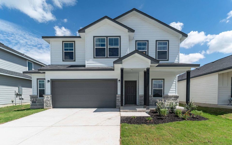 Front exterior of a new home in Swenson Heights, Seguin, TX, highlighting curb appeal (Image 1).