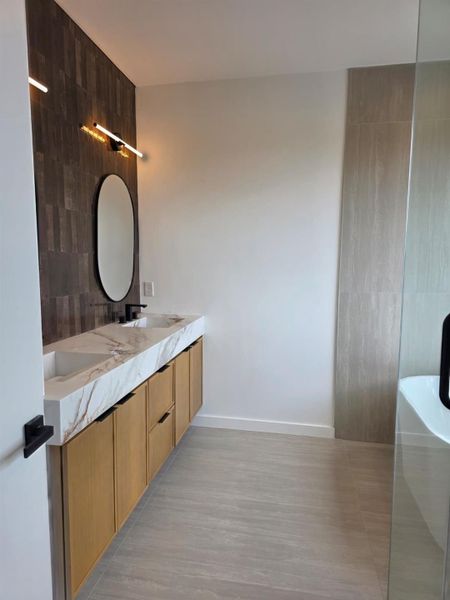 High-end bespoke gallery look achieved with stone like quartzite flowing from the counter straight into the basin