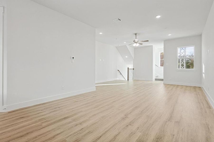 Unfurnished living room featuring baseboards, visible vents, light wood finished floors, recessed lighting, and ceiling fan