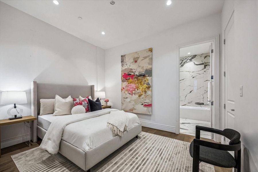 This secondary bedroom offers a comfortable & versatile layout with soft finishes, warm wood flooring & designer touches throughout. With direct access to a beautifully appointed bath, it’s an ideal space for guests or a private retreat.
