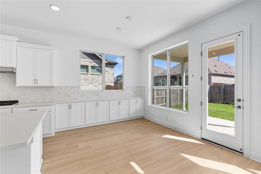 Unfurnished dining area featuring light wood-type flooring and recessed lighting