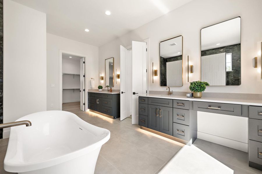 Bathroom featuring recessed lighting, a freestanding bath, vanity, and a spacious closet