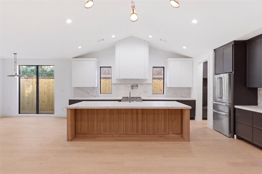 The expansive open-concept layout seamlessly connects the living, dining, and kitchen areas—perfect for both everyday living and entertaining.