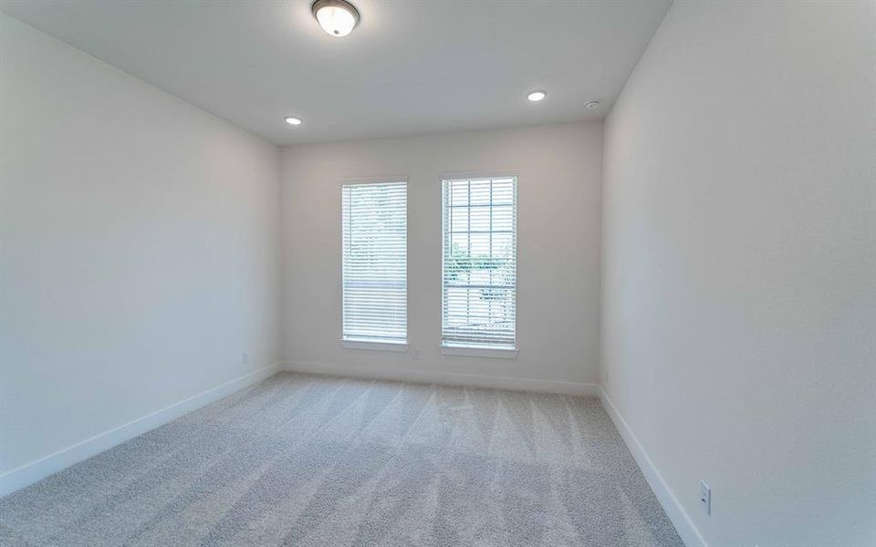 Room with plush carpet flooring, two large windows with blinds, recessed lighting, and a flush mount ceiling fixture