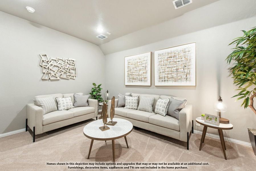 Living room with two beige sofas, round coffee table, and vaulted ceiling over neutral carpet Living room with two beige sofas, round coffee table, and vaulted ceiling over neutral carpet