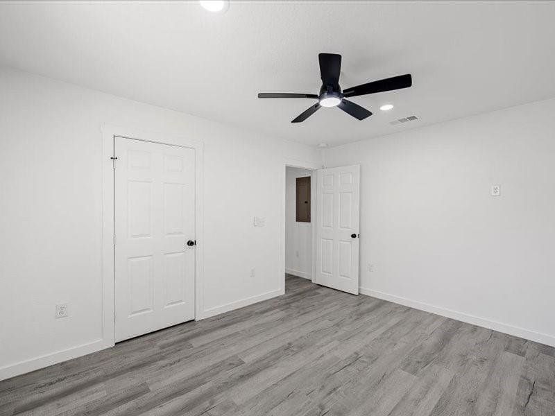 Unfurnished bedroom with light wood finished floors, ceiling fan, and recessed lighting