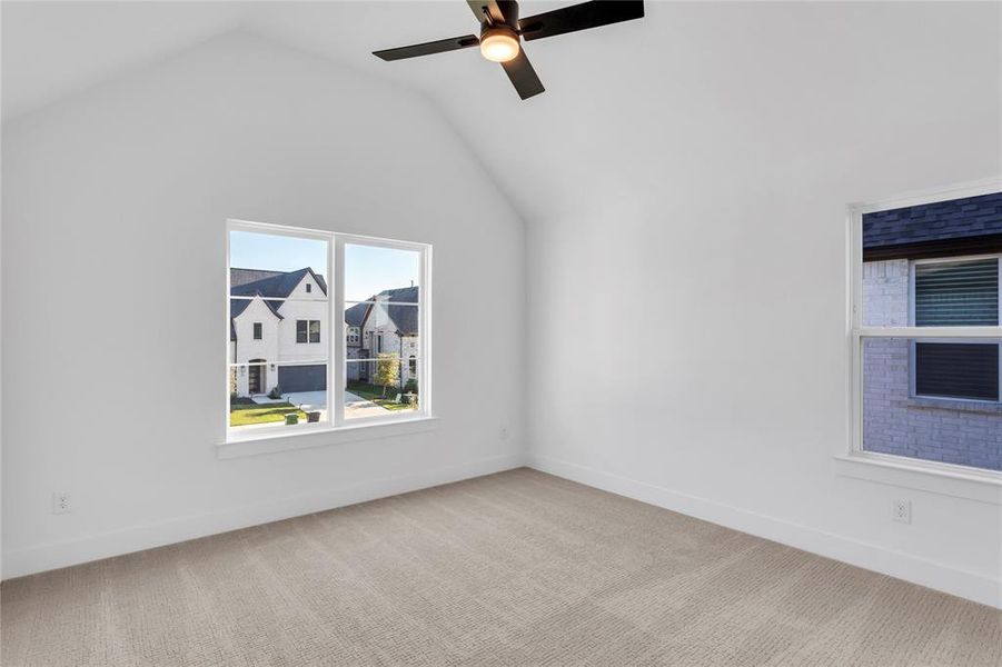 Bonus room with carpet floors, vaulted ceiling, and ceiling fan