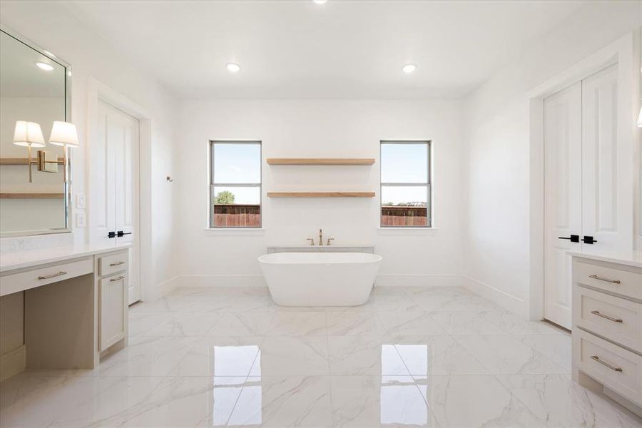 Bathroom with vanity and a tub