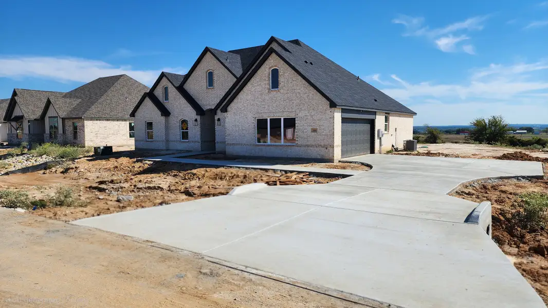 Front exterior of a new home in Stagecoach Crossing, Bridgeport, TX, highlighting curb appeal (Image 2). Front exterior of a new home in Stagecoach Crossing, Bridgeport, TX, highlighting curb appeal (Image 2).