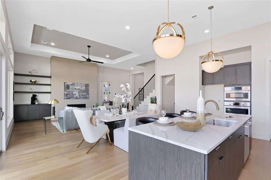 Open-concept kitchen and living area featuring light wood-finish flooring