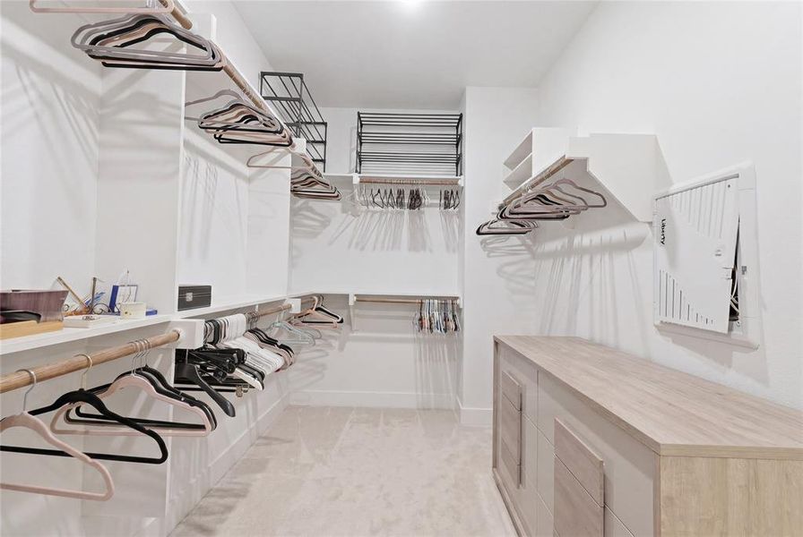 Walk-in closet featuring built-in shelving, and multiple hanging rods Walk-in closet featuring built-in shelving, and multiple hanging rods