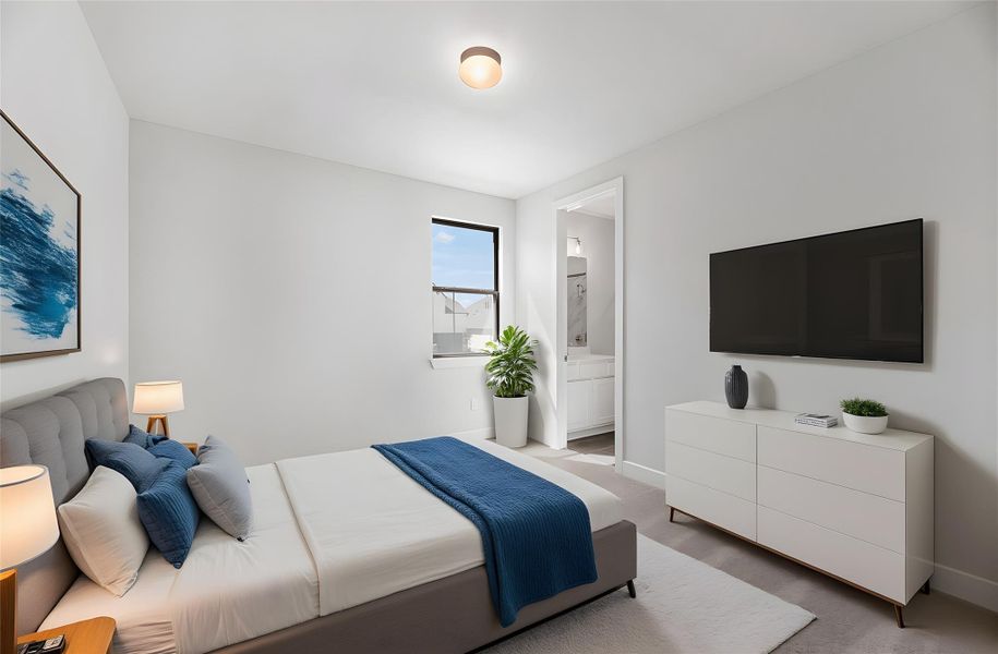 Carpeted bedroom featuring baseboards and ensuite bath