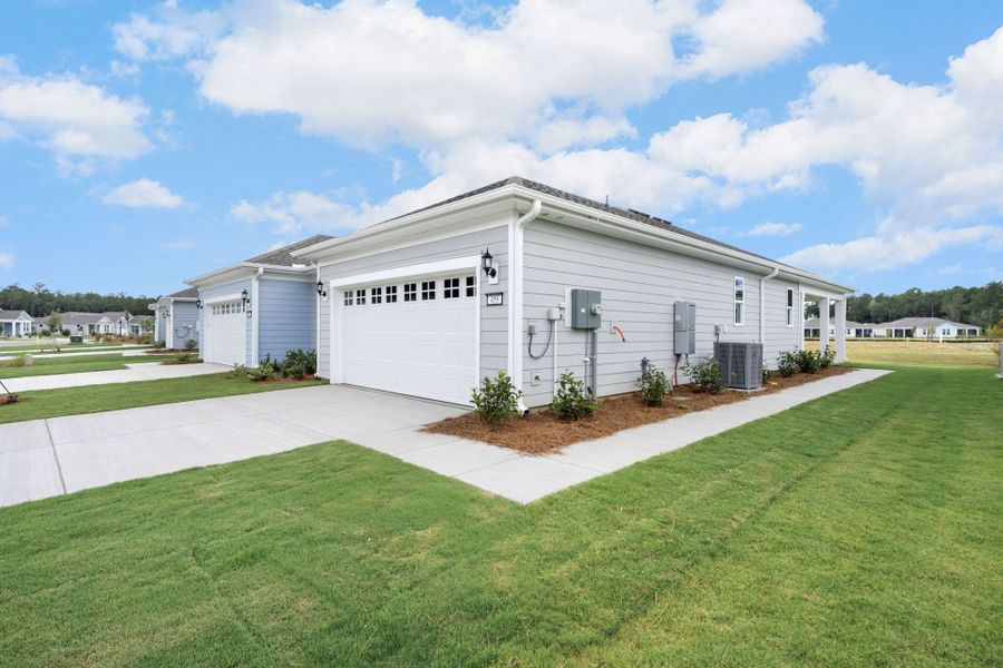 Front exterior of a new home in Sun City Hilton Head, Bluffton, SC, highlighting curb appeal (Image 2). Front exterior of a new home in Sun City Hilton Head, Bluffton, SC, highlighting curb appeal (Image 2).