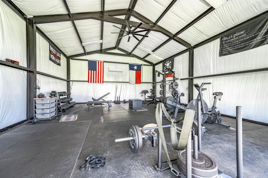 Inside the barn-style building, you’ll find a spacious climate-controlled gym area with high ceilings and ample room for a variety of equipment and activities. This flexible space offers excellent potential for fitness, recreation, hobbies, or customized use to fit your lifestyle.