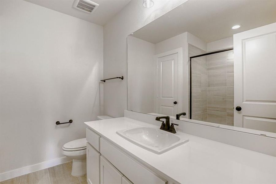 Bathroom with vanity and a shower stall