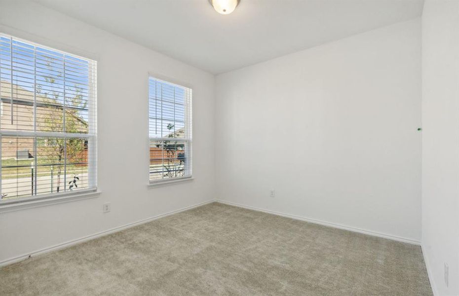 Spacious secondary bedroom with large windows *real home pictured