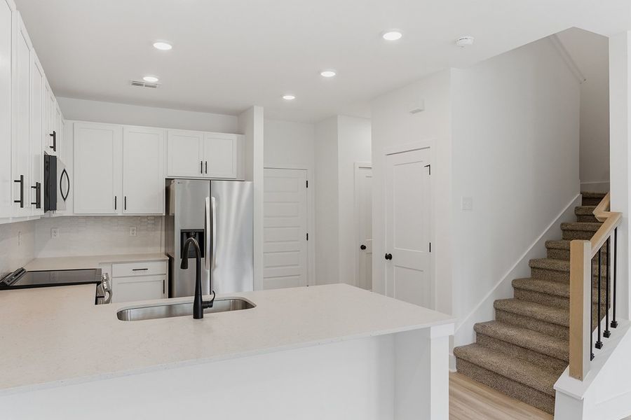 A kitchen with white cabinets. A kitchen with white cabinets.