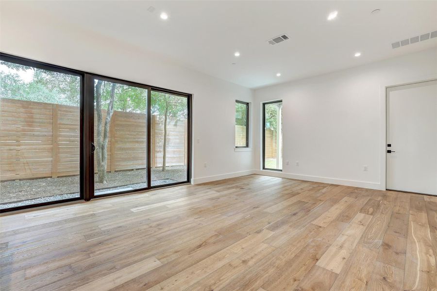Empty room with light wood-type flooring and recessed lighting Empty room with light wood-type flooring and recessed lighting