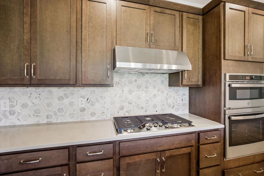 This kitchen features our gourmet kitchen layout which includes a gas range with vent hood and a double stack oven and microwave