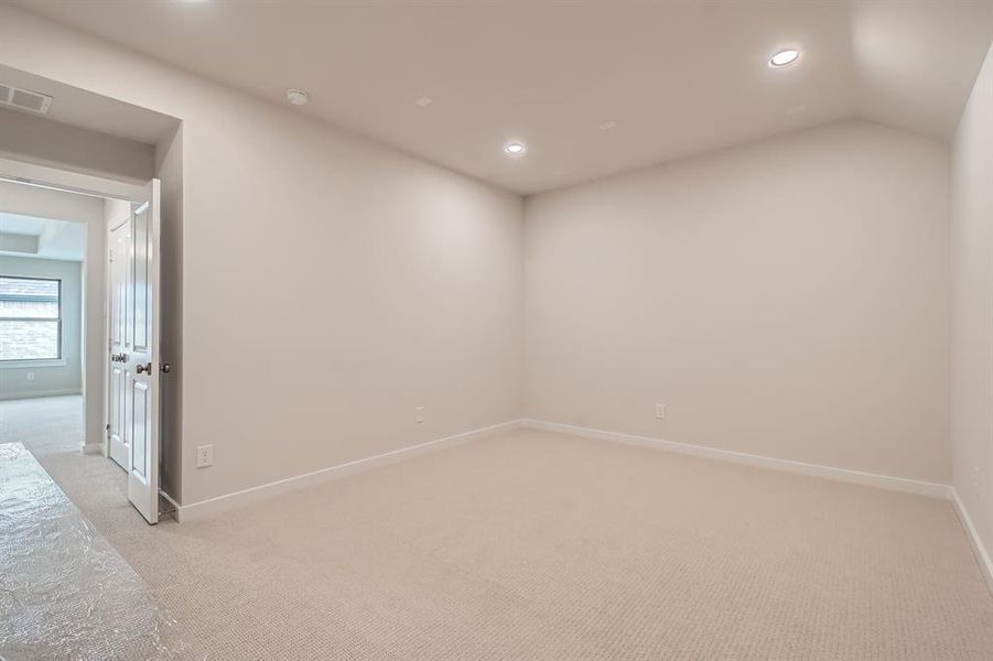 Empty room featuring light carpet and recessed lighting Empty room featuring light carpet and recessed lighting