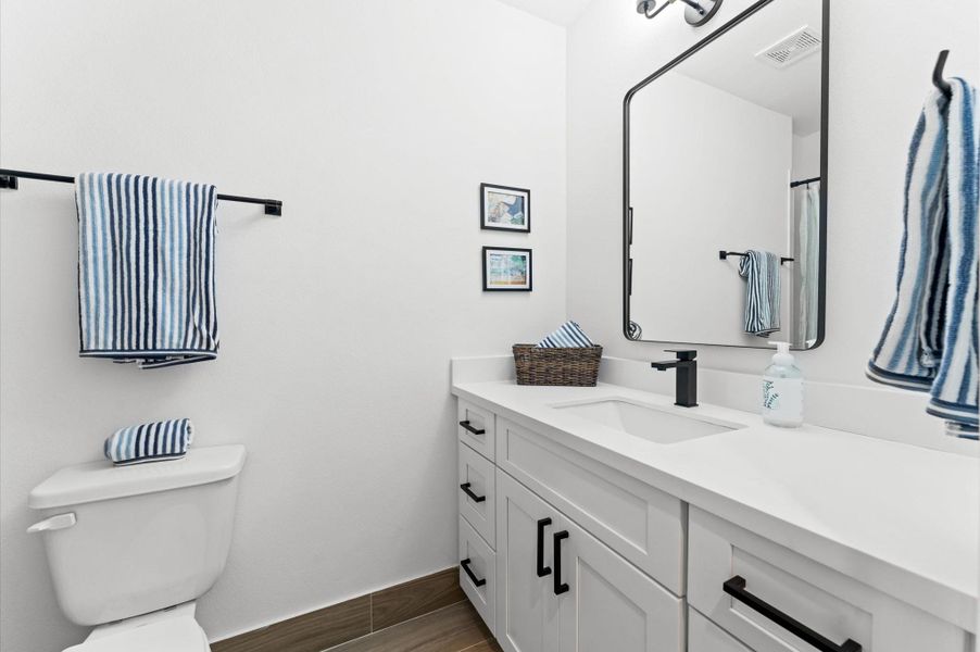 This inviting home features two spacious secondary bedrooms located on the first floor, offering privacy and convenience for guests, family members, or a home office setup. A full bathroom is thoughtfully positioned nearby, providing easy access and functionality. Whether used for multi-generational living or flexible space needs, this layout enhances comfort and accessibility without compromising style.