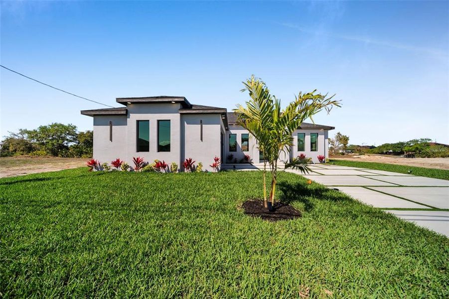 Front exterior of a new home in , Cape Coral, FL, highlighting curb appeal (Image 28). Front exterior of a new home in , Cape Coral, FL, highlighting curb appeal (Image 28).