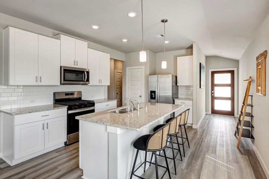 The kitchen features stainless steel appliances, including a gas stovetop. The kitchen features stainless steel appliances, including a gas stovetop.