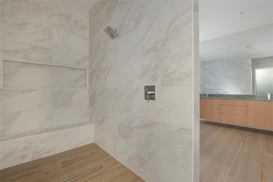 Bathroom with a tile shower and vanity