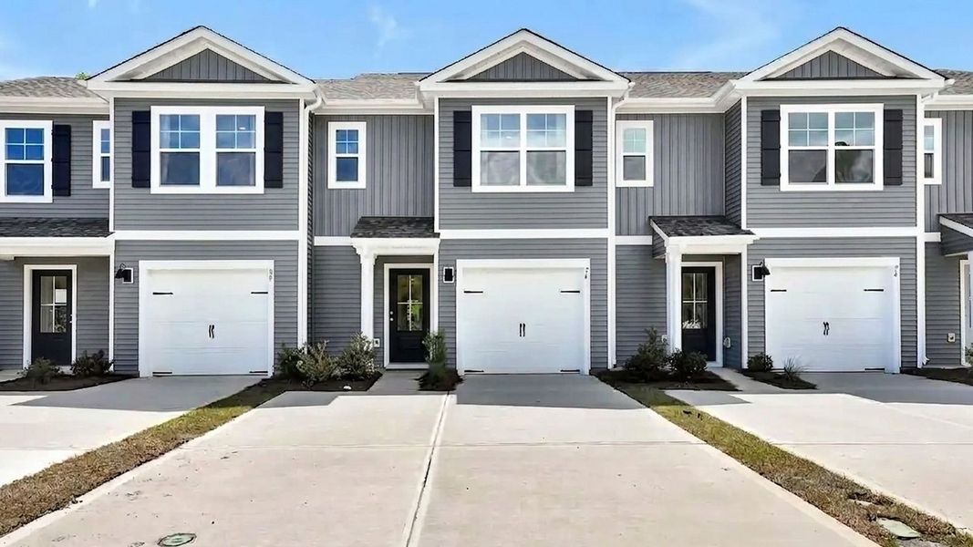 Front exterior of a new home in The Landing at Sidbury Station, Castle Hayne, NC, highlighting curb appeal (Image 1). Front exterior of a new home in The Landing at Sidbury Station, Castle Hayne, NC, highlighting curb appeal (Image 1).