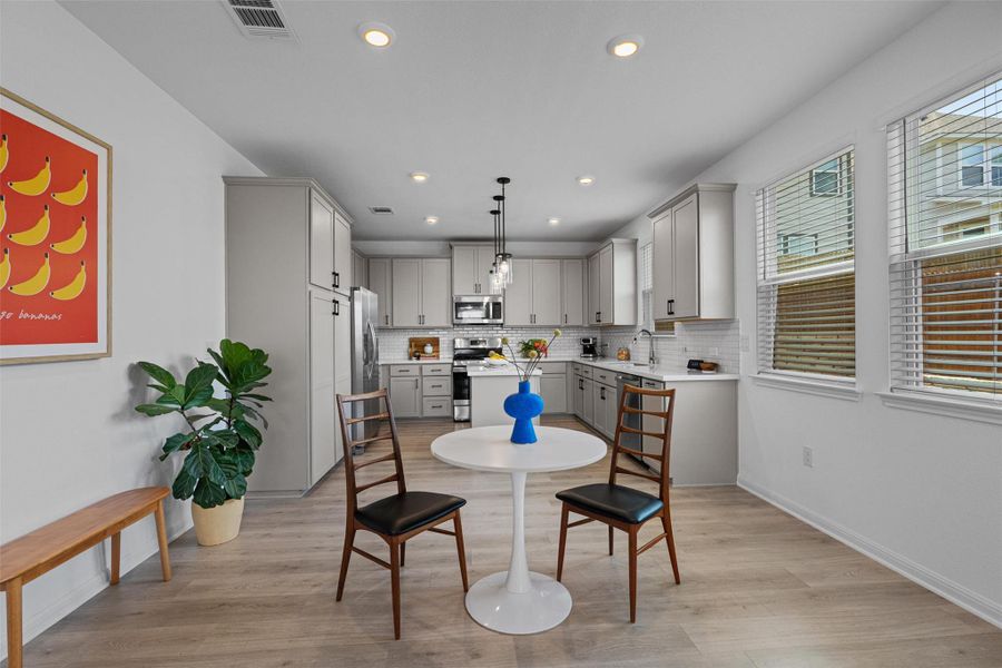 Dining space with  recessed lighting is open to the kitchen