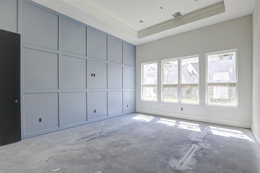 Unfurnished living room featuring a fireplace and a high ceiling