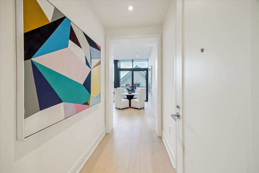 Entry foyer to residence filled with light from east windows and showcase wall space.