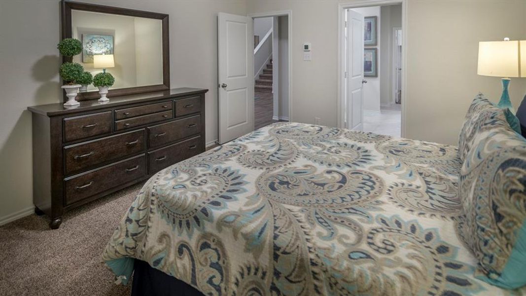 Bedroom with light carpet and baseboards